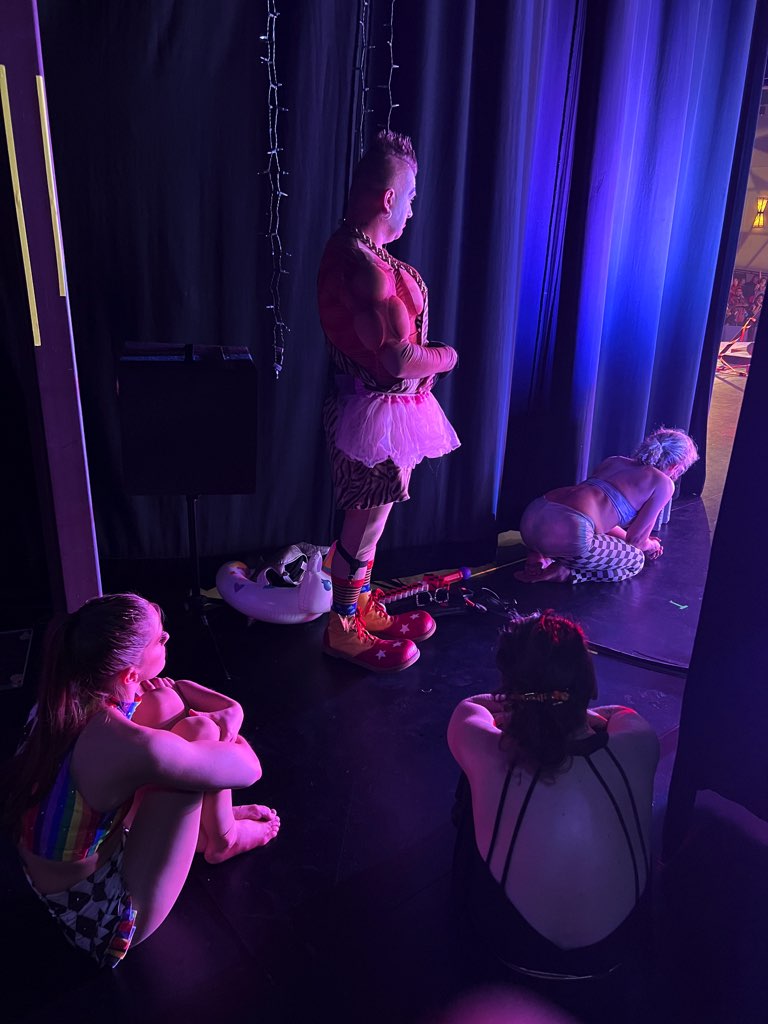 Performers backstage watching the show